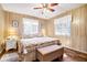 Cozy bedroom with wood paneled walls and a comfortable king sized bed next to bedside tables with lamps at 3323 Myrtle St, Edisto Island, SC 29438