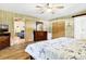 Inviting bedroom with wood paneling, hardwood floors and nautical themed quilt at 3323 Myrtle St, Edisto Island, SC 29438