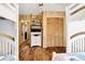 Comfortable bedroom features wood paneling, hardwood floors, built-in shelves and closet at 3323 Myrtle St, Edisto Island, SC 29438