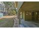 View of home's bottom level outdoor entryway with stone pathway and tropical landscaping at 3323 Myrtle St, Edisto Island, SC 29438