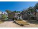 Exterior view of a stilt home with a gravel driveway and palm trees at 3323 Myrtle St, Edisto Island, SC 29438