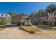 Inviting elevated house boasts classic architectural lines and a well-maintained yard at 3323 Myrtle St, Edisto Island, SC 29438
