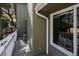 View of home's side porch with chairs, plants, green exterior, and large windows at 3323 Myrtle St, Edisto Island, SC 29438