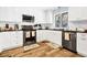 Well-lit kitchen with white cabinets, stainless steel appliances, and sleek countertops at 3323 Myrtle St, Edisto Island, SC 29438