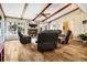 Cozy living room boasts vaulted ceilings, wood beams, a fireplace, and comfortable leather seating at 3323 Myrtle St, Edisto Island, SC 29438