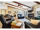 Spacious living room with a brick fireplace, ceiling beams, and cozy seating at 3323 Myrtle St, Edisto Island, SC 29438