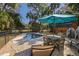 Inviting backyard pool area featuring a patio, lounge chairs, and lush tropical landscaping at 3323 Myrtle St, Edisto Island, SC 29438