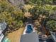 Aerial view of a kidney-shaped pool surrounded by palm trees and lush landscaping at 3323 Myrtle St, Edisto Island, SC 29438