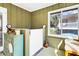 Bright sun room with windows, tiled floor, and green paneled walls at 3323 Myrtle St, Edisto Island, SC 29438