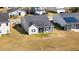 Aerial view of a home with gray roof, green lawn and screened-in porch at 3707 Blackjack Rd, Ladson, SC 29456