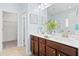 Bathroom featuring a double sink vanity with wood cabinets, a large mirror, and walk-in closet at 3707 Blackjack Rd, Ladson, SC 29456