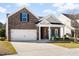 Beautiful brick home with a well-manicured lawn, two-car garage, and inviting covered porch at 3707 Blackjack Rd, Ladson, SC 29456