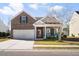 Charming brick home with a two-car garage, covered porch and manicured lawn at 3707 Blackjack Rd, Ladson, SC 29456