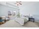 Bright main bedroom with a tray ceiling, large window, and a cozy sitting area with a reading chair at 3707 Blackjack Rd, Ladson, SC 29456