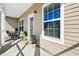 Inviting covered porch featuring rocking chairs and various plants at 3707 Blackjack Rd, Ladson, SC 29456