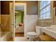 Cozy bathroom featuring a tub, toilet, and sink, showcasing a clean and functional design with tiled accents at 408 N Parler Ave, Saint George, SC 29477