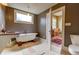 Charming bathroom with a freestanding tub and a sink with stone countertop, showcasing classic design elements at 408 N Parler Ave, Saint George, SC 29477