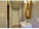 Bathroom featuring a shower, a vanity sink with a decorative framed mirror and neutral wall paint at 408 N Parler Ave, Saint George, SC 29477