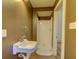 Bathroom showcasing a standing shower, a wall sink, neutral walls and neutral floor tiles at 408 N Parler Ave, Saint George, SC 29477