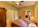 Inviting bedroom with hardwood floors, a ceiling fan, and traditional wood accents, bathed in natural light at 408 N Parler Ave, Saint George, SC 29477