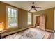 Bedroom with wood floors, vintage windows, and a ceiling fan, with muted neutral tones and inviting natural light at 408 N Parler Ave, Saint George, SC 29477