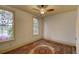 Bedroom featuring windows that provide natural light and a decorative area rug over hardwood flooring at 408 N Parler Ave, Saint George, SC 29477