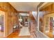 Welcoming foyer featuring wood paneling, hardwood floors, staircase, and an open floor plan, exuding character at 408 N Parler Ave, Saint George, SC 29477