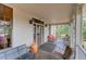 Inviting front porch with seating area, views of the surrounding landscape and ample space for relaxation at 408 N Parler Ave, Saint George, SC 29477