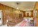 Hallway featuring a staircase, hardwood floors, and wood-paneled walls, leading to other areas of the home at 408 N Parler Ave, Saint George, SC 29477