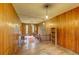 Hallway with wood-paneled walls, a staircase, and hardwood floors, creating an inviting and character-filled space at 408 N Parler Ave, Saint George, SC 29477