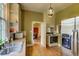 Galley kitchen with stainless steel appliances and light-colored cabinets, view to living spaces at 408 N Parler Ave, Saint George, SC 29477