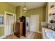 Galley kitchen features stainless steel appliances, light-colored cabinets, and hardwood floors at 408 N Parler Ave, Saint George, SC 29477