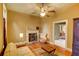 Comfortable living room with fireplace, hardwood floors, and tan walls with views to dining area at 408 N Parler Ave, Saint George, SC 29477