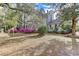Landscaped yard featuring flowering shrubs and mature trees provide shade and privacy at 408 N Parler Ave, Saint George, SC 29477