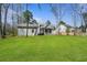 Spacious backyard with lush green grass and a view of the house and garage at 4217 Royal Harbor Rd, Hollywood, SC 29449