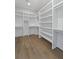 Spacious walk-in closet with shelving and hardwood floors at 4217 Royal Harbor Rd, Hollywood, SC 29449