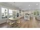Bright dining area located adjacent to the modern white kitchen and a window view at 4217 Royal Harbor Rd, Hollywood, SC 29449