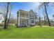 Beautiful two-story home with a double balcony, manicured lawn and large trees at 4217 Royal Harbor Rd, Hollywood, SC 29449