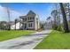 Charming two-story home with a welcoming front porch, lush lawn, and convenient driveway at 4217 Royal Harbor Rd, Hollywood, SC 29449
