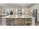 Elegant white kitchen features a large island with seating, stainless steel appliances, and natural light at 4217 Royal Harbor Rd, Hollywood, SC 29449