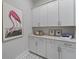 Laundry room featuring modern white cabinetry and stylish tile flooring at 4217 Royal Harbor Rd, Hollywood, SC 29449