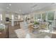 Open concept living room featuring a stylish sofa, bright kitchen, and an outdoor patio at 4217 Royal Harbor Rd, Hollywood, SC 29449
