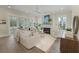 Open-concept living room with a fireplace, large windows, stylish furniture, and wood flooring at 4217 Royal Harbor Rd, Hollywood, SC 29449
