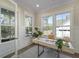 Bright home office with decorative wainscoting, modern desk, and sunlit windows overlooking the front yard at 4217 Royal Harbor Rd, Hollywood, SC 29449
