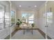 Sunlit home office featuring glass French doors, wainscoting, and a view to the outside at 4217 Royal Harbor Rd, Hollywood, SC 29449