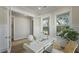 Cozy home office featuring hardwood floors, wainscoting, a stylish desk, and views to the outdoors at 4217 Royal Harbor Rd, Hollywood, SC 29449