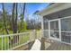 Screened porch with wooden flooring and railings that overlook a wooded area at 4217 Royal Harbor Rd, Hollywood, SC 29449