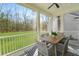 Screened porch with ceiling fan and outdoor seating with a wooded view at 4217 Royal Harbor Rd, Hollywood, SC 29449