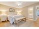 Cozy bedroom featuring wood floors, a comfortable bed, and a full ensuite bathroom at 433 Double Eagle Trace, Seabrook Island, SC 29455