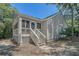 Exterior with screened porch, decorative front door, and low-maintenance yard at 433 Double Eagle Trace, Seabrook Island, SC 29455